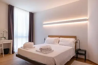 Letto o letti in una camera di [Attico di Design] a 5 min da Centro e Fiera