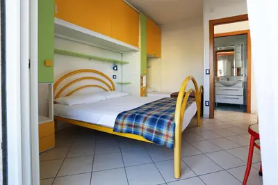 Letto o letti in una camera di Residence La Pigna