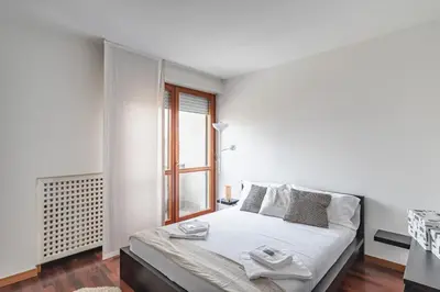 Letto o letti in una camera di GuestHost - Padova Palestro Pastel Apartment