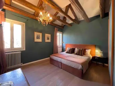 Letto o letti in una camera di Cà Cornelia - a rooftop terrace with dazzling view